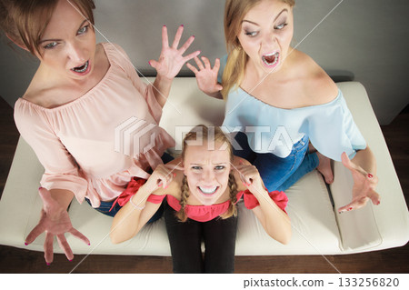 Woman being bullied by two females Woman being bullied by two females 133256820