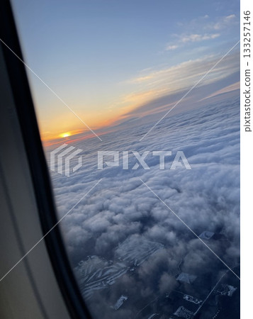A sunset glow seen from an airplane A sunset glow seen from an airplane 133257146