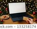 Holiday online shopping scene with cookies and festive decorations in the background 133258174
