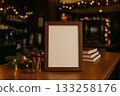 Cozy coffee shop display with empty frame, festive decor, and Christmas lights in evening setting 133258176