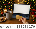 Cozy holiday workspace with warm drinks, treats, and soft lights 133258179