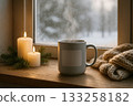 Cozy winter scene with warm drink and candles by the snowy window 133258182