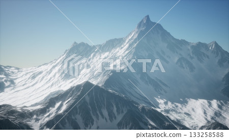 Snow covered peaks rise against a bright blue sky, with sunlight illuminating the rugged terrain. The serene atmosphere invites adventure and reflection in natures splendor. 133258588