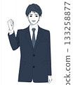 A young man in a suit smiling and pumping his fist 133258877