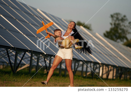 Mother with her little son are near the solar panels Mother with her little son are near the solar panels 133259270
