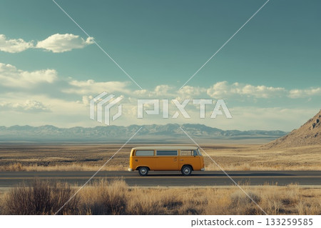 Retro Yellow Van on Open Road with Scenic Mountains and Cloudy Sky in Desert Landscape Retro Yellow Van on Open Road with Scenic Mountains and Cloudy Sky in Desert Landscape 133259585