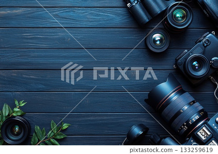 A collection of camera equipment is displayed on a wooden surface 133259619