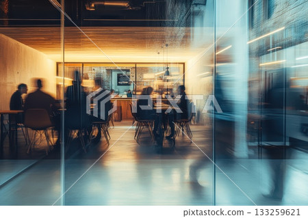 Modern office space with people working and blurred motion creating a sense of dynamism 133259621