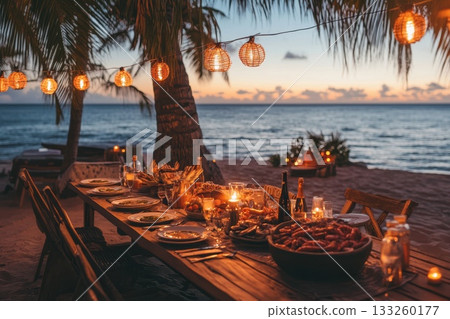 Romantic Beach Dinner at Sunset with Lanterns and Delicious Food Setup Romantic Beach Dinner at Sunset with Lanterns and Delicious Food Setup 133260177