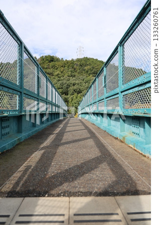 Pedestrian bridge, mountains and clouds Pedestrian bridge, mountains and clouds 133260761