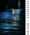 Rain-soaked road illuminated by light at night 133261410