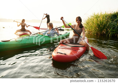 On the lake. Friends are together on sup boards 133261670