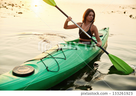 Learning process, joy. Young woman is with the sup board on the lake Learning process, joy. Young woman is with the sup board on the lake 133261923