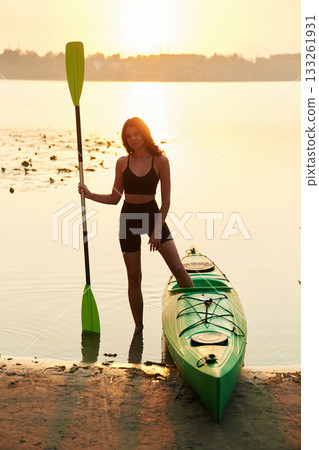 Model is standing and posing. Young woman is with the sup board on the lake 133261931