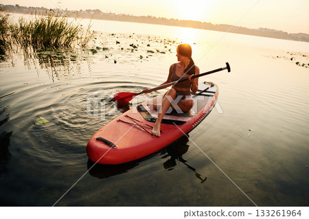 Young woman is with the sup board on the lake Young woman is with the sup board on the lake 133261964