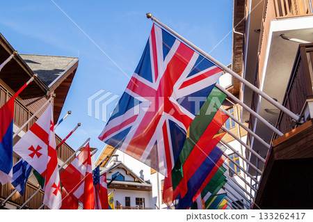 Flags of the world display in vibrant street during sunny day in a lively town center 133262417