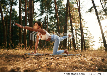 Stretching exercises. Woman is doing yoga fitness exercises in the forest 133262918