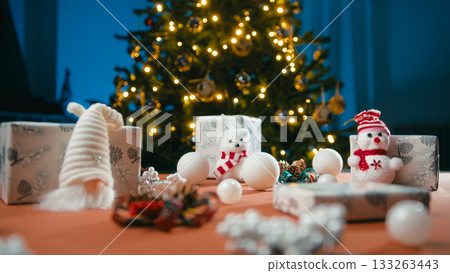 Christmas table with ornaments, puppets and gifts for children Christmas table with ornaments, puppets and gifts for children 133263443