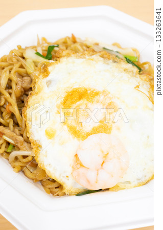 Delicious Shanghai fried noodles topped with a fried egg Delicious Shanghai fried noodles topped with a fried egg 133263641