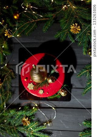 Festive Red Cake Adorned With Golden Decorations and Greenery, Set Against a Backdrop of Sparkling Lights During a Holiday Celebration Festive Red Cake Adorned With Golden Decorations and Greenery, Set Against a Backdrop of Sparkling Lights During a Holiday Celebration 133263806