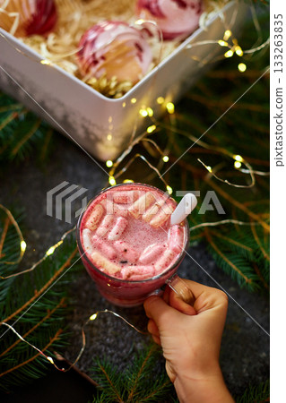 Festive Holiday Dessert Drink Topped With Marshmallows and Served in a Cozy Setting With Twinkling Lights 133263835
