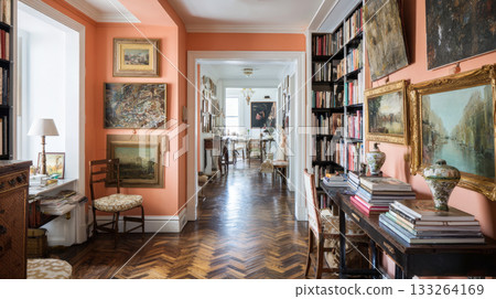 Luxurious, bohemian apartment interior with peach-colored walls, herringbone parquet flooring, and a long hallway lined with a gallery wall of art, antique furniture, and bookshelves Luxurious, bohemian apartment interior with peach-colored walls, herringbone parquet flooring, and a long hallway lined with a gallery wall of art, antique furniture, and bookshelves 133264169