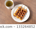 Mitarashi dango and tea on a white plate 133264852