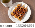 Mitarashi dango and tea on a white plate 133264854