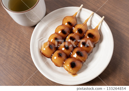 Mitarashi dango and tea on a white plate Mitarashi dango and tea on a white plate 133264854