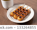 Mitarashi dango and tea on a white plate 133264855