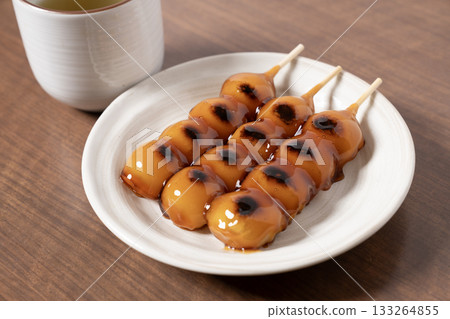 Mitarashi dango and tea on a white plate 133264855