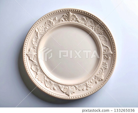 Formal dinner. Ceramic plate with a classic white design and floral border on a white background. Porcelain kitchenware. Close-up. Top view. Formal dinner. Ceramic plate with a classic white design and floral border on a white background. Porcelain kitchenware. Close-up. Top view. 133265036
