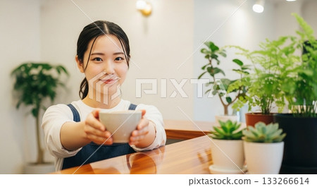 A woman working in a cafe 133266614