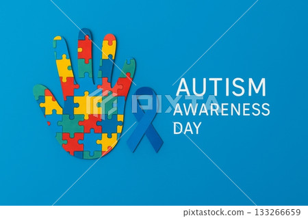 Autism Awareness Day puzzle concept featuring colorful hand and blue ribbon 133266659