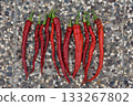red hot peppers over stone background 133267802