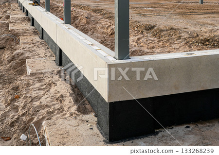 Concrete building foundation with waterproofing layer during early construction stage Concrete building foundation with waterproofing layer during early construction stage 133268239