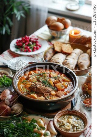 Festive table set for Finnish Independence Day featuring traditional cuisine like karjalanpiirakka, lohikeitto and pulla. Celebration arrangement 133268450