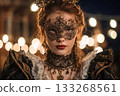 A girl in a mask and Victorian Gothic dress poses at a night carnival against the backdrop of garlands of lights creating bokeh. Festival, holiday, outdoor night party 133268561