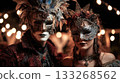 A couple wearing a mask and Victorian Gothic costume poses at a nighttime carnival against a backdrop of garlands creating a bokeh effect. Festival, holiday, outdoor night party 133268562