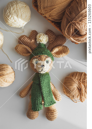 Crocheted Reindeer Toy with Yarn and Crafting Tools in Cozy Workspace Crocheted Reindeer Toy with Yarn and Crafting Tools in Cozy Workspace 133268603