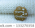 Gingerbread cookie decorated with royal icing on white knitted background. Merry Christmas 133270358