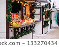 Christmas street market. Wooden houses for selling Christmas decorations and toys. Winter holiday season. 133270434
