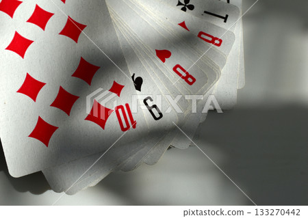 Playing cards are fanned out on the table. Playing cards are fanned out on the table. 133270442