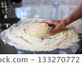 Making Fresh Yeast Dough by Hand with Flour on Kitchen Table, Close Up Process 133270772