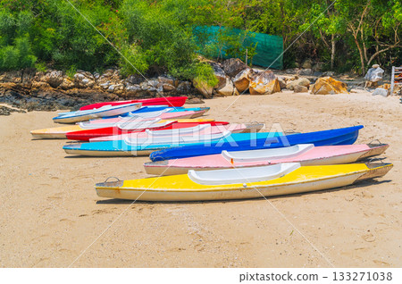 Kayaks on the sandy beach by sea in in summer on a sunny day Kayaks on the sandy beach by sea in in summer on a sunny day 133271038