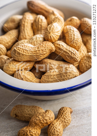 Peanuts in shell. Groundnuts in bowl on kitchen table. Peanuts in shell. Groundnuts in bowl on kitchen table. 133271272