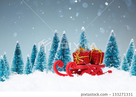 captivating holiday artwork showcasing sled loaded with gifts surrounded by snowy trees and gentle snow 133271331