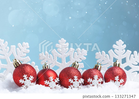 festive ornament display, decorative red ornaments set in wintery festive environment with shimmer 133271347