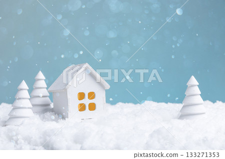 idyllic winter setting showcasing litup house surrounded by softly piled snow and pine shadows 133271353