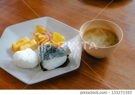 A Japanese breakfast of rice balls, tamagoyaki (rolled egg), fried potatoes, and miso soup A Japanese breakfast of rice balls, tamagoyaki (rolled egg), fried potatoes, and miso soup 133271383